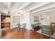 Dining area and living room with hardwood floors, exposed beam ceiling, and unique decor at 4801 E 9Th Ave # 402S, Denver, CO 80220