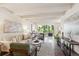 Open-concept living room with hardwood floors, exposed beam ceiling and plenty of natural light at 4801 E 9Th Ave # 402S, Denver, CO 80220