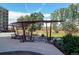 An outdoor seating area with shaded spots, walkways, and a communal grill at 4801 E 9Th Ave # 402S, Denver, CO 80220