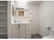 Well-lit bathroom featuring a modern vanity with sleek fixtures and plenty of storage space at 14150 E Temple Dr # V06, Aurora, CO 80015