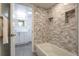 Bathroom view showcasing a luxurious tub with elegant marble tiling and a modern vanity at 14150 E Temple Dr # V06, Aurora, CO 80015