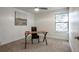 Inviting bedroom with a ceiling fan, a large window, and a desk bathed in natural light at 14150 E Temple Dr # V06, Aurora, CO 80015