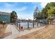 Exterior view of a community pool with a black fence and mature trees on a clear, sunny day at 14150 E Temple Dr # V06, Aurora, CO 80015