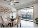 Dining area with a glass table, comfortable chairs, and sliding doors to the balcony at 14150 E Temple Dr # V06, Aurora, CO 80015