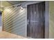 An external safety screen door protects an apartment entrance with green siding and an external light at 14150 E Temple Dr # V06, Aurora, CO 80015