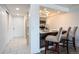 Hallway view of kitchen with breakfast bar and modern gray cabinets at 14150 E Temple Dr # V06, Aurora, CO 80015