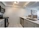 Modern kitchen with stainless steel appliances, marble floors, and gray cabinets at 14150 E Temple Dr # V06, Aurora, CO 80015