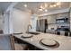 Bright kitchen featuring stainless steel appliances, gray cabinetry, and a marble countertop with a breakfast bar at 14150 E Temple Dr # V06, Aurora, CO 80015