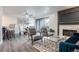 Open-concept living and dining area featuring a fireplace and access to the balcony at 14150 E Temple Dr # V06, Aurora, CO 80015