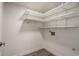 Bright pantry features white walls, light gray wood floors and ample white shelving at 14150 E Temple Dr # V06, Aurora, CO 80015