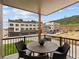 Outdoor balcony with a table and chairs overlooking a neighborhood, perfect for enjoying outdoor relaxation and views at 14492 Pansy Loop, Morrison, CO 80465