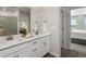 Bathroom with double vanity, white cabinets and quartz counters at 14492 Pansy Loop, Morrison, CO 80465