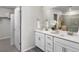 Bathroom with double vanity, white cabinets and quartz counters at 14492 Pansy Loop, Morrison, CO 80465