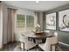 Bright dining room features a round table, modern art, and window views at 14492 Pansy Loop, Morrison, CO 80465