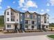 View of stylish townhouses with multi-tone exteriors, small balconies, and landscaped frontage at 14492 Pansy Loop, Morrison, CO 80465