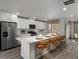 Modern kitchen featuring white cabinets, stainless appliances, and spacious island with seating at 14492 Pansy Loop, Morrison, CO 80465
