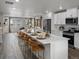 Island kitchen with white cabinets, stainless appliances, and breakfast bar seating at 14492 Pansy Loop, Morrison, CO 80465