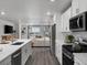 Open kitchen with quartz counters, stainless appliances, and sight lines to living room at 14492 Pansy Loop, Morrison, CO 80465