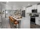Island kitchen with white cabinets, stainless appliances, and breakfast bar seating at 14492 Pansy Loop, Morrison, CO 80465