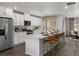 Modern kitchen featuring white cabinets, stainless appliances, and spacious island with seating at 14492 Pansy Loop, Morrison, CO 80465