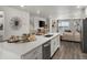 Open kitchen with quartz counters, stainless appliances, and sight lines to living room at 14492 Pansy Loop, Morrison, CO 80465