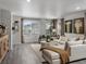 Bright living room featuring modern decor, large windows, and neutral color palette at 14492 Pansy Loop, Morrison, CO 80465
