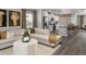 Open-concept space showcasing a living room connected to a kitchen with breakfast bar seating at 14492 Pansy Loop, Morrison, CO 80465