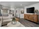 A bright living room showing open floor plan leading to dining and kitchen areas at 14492 Pansy Loop, Morrison, CO 80465