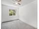 Inviting bedroom featuring plush carpet, a ceiling fan, and a large window at 707 W 96Th Ave # 5, Thornton, CO 80260
