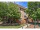 Beautiful building with a blend of textures and mature trees on a bright and sunny day at 707 W 96Th Ave # 5, Thornton, CO 80260