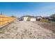 Large backyard features a long driveway and a wood fence at 3110 W 66Th Ave, Denver, CO 80221