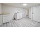 Finished basement area with utility sink, modern cabinets and recessed lighting at 3110 W 66Th Ave, Denver, CO 80221