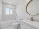 Beautiful bathroom featuring patterned tile accent wall and classic fixtures at 3110 W 66Th Ave, Denver, CO 80221
