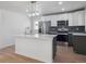 Modern kitchen with stainless steel appliances, ample counter space, and stylish cabinets at 3110 W 66Th Ave, Denver, CO 80221