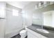 Well-lit bathroom features a shower and modern vanity with a gray countertop and white cabinets at 8722 E 47Th Ave, Denver, CO 80238