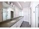 Modern bathroom features double sinks, gray counters, white cabinets, and a glass-enclosed shower at 8722 E 47Th Ave, Denver, CO 80238