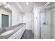 Spacious bathroom features a modern vanity with double sinks and a shower with glass doors at 8722 E 47Th Ave, Denver, CO 80238