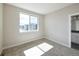 Bedroom features a large window overlooking building and is adjacent to a bathroom at 8722 E 47Th Ave, Denver, CO 80238