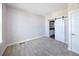 Bright bedroom featuring plush carpet, neutral walls, and access to a bathroom through barn doors at 8722 E 47Th Ave, Denver, CO 80238