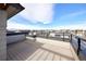 A spacious outdoor deck featuring modern railings and expansive community views at 8722 E 47Th Ave, Denver, CO 80238