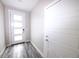 Bright entryway featuring a modern front door with glass panels and sleek gray wood-look flooring at 8722 E 47Th Ave, Denver, CO 80238
