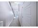 Carpeted hallway features access to other rooms in the house and a modern staircase at 8722 E 47Th Ave, Denver, CO 80238
