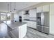 An elegant kitchen featuring modern appliances, quartz countertops, and a large kitchen island at 8722 E 47Th Ave, Denver, CO 80238