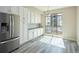 Modern kitchen with white cabinets, stainless steel appliances, and sliding glass doors to the outside at 8722 E 47Th Ave, Denver, CO 80238