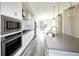 A bright kitchen featuring stainless steel appliances, quartz countertops, and modern white cabinetry at 8722 E 47Th Ave, Denver, CO 80238