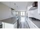 A modern kitchen with stainless steel appliances, quartz countertops, and stylish pendant lighting at 8722 E 47Th Ave, Denver, CO 80238