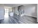 An open concept floor plan featuring modern kitchen and living room space with staircase at 8722 E 47Th Ave, Denver, CO 80238