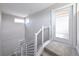 Bright staircase with a glass door to the patio and modern railings leading to the upper level at 8722 E 47Th Ave, Denver, CO 80238