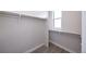 Bright walk-in closet featuring carpeted floors, ample hanging space, and a window for natural light at 8722 E 47Th Ave, Denver, CO 80238