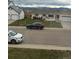 Residential home with a yard, driveway and view of distant mountains at 1506 Maple Dr, Berthoud, CO 80513